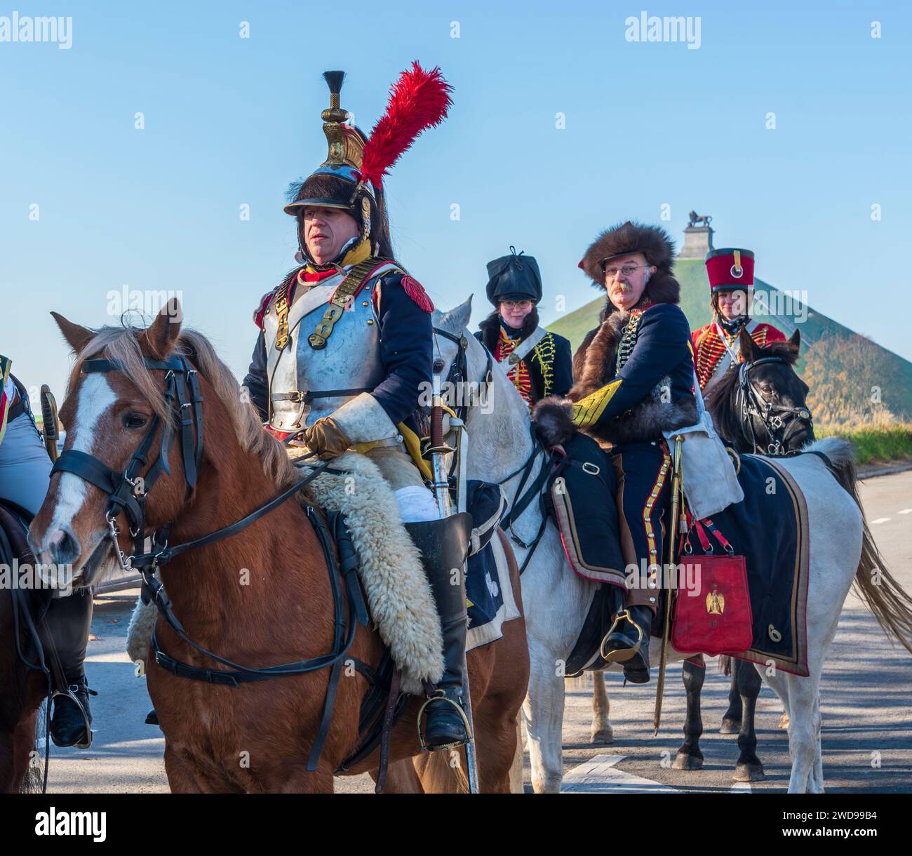 Reenattori in uniformi napoleoniche a cavallo al campo di battaglia di Waterloo Foto Stock