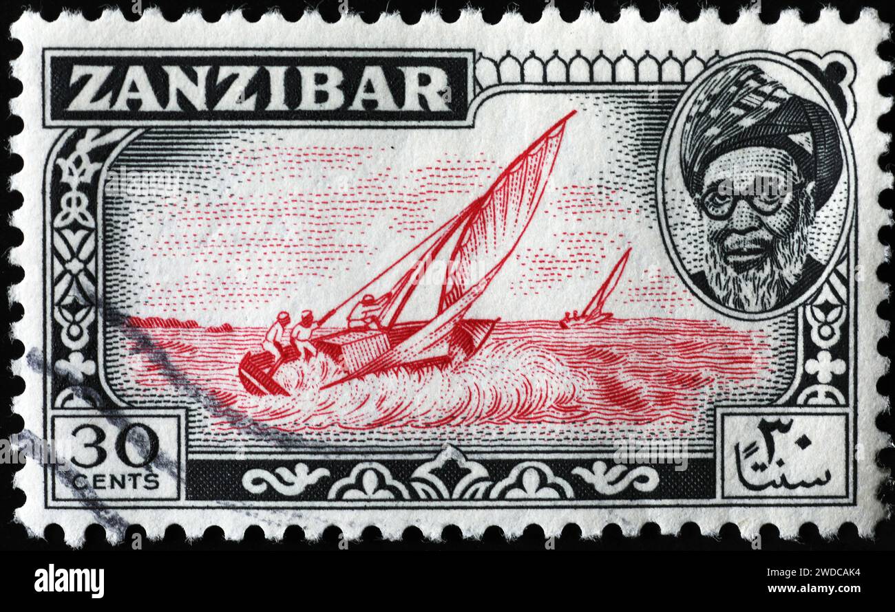 Antico francobollo di Zanzibar con una barca a vela Foto Stock