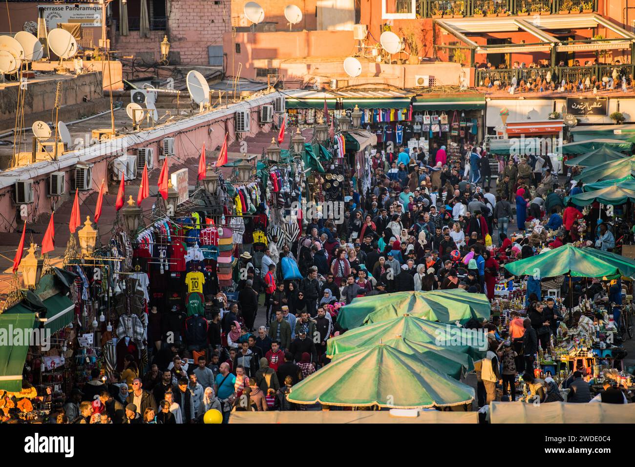 Marrakech, Marocco-28 febbraio 2023: Una strada tipica nell'antico quartiere Medina di Marrakech. La foto contiene persone locali che svolgono varie attività Foto Stock