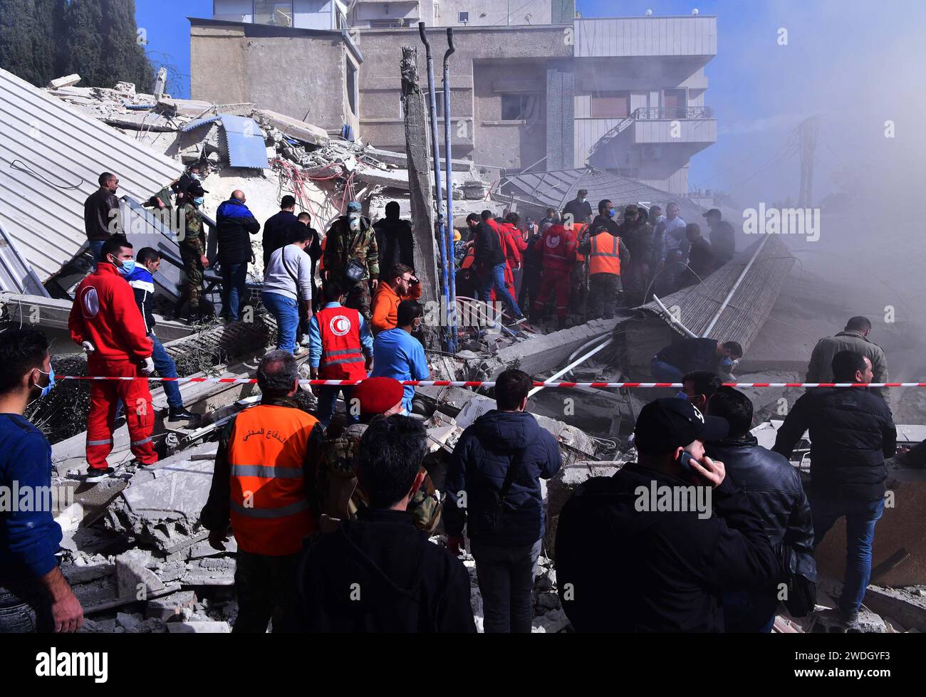 Damasco, Siria. 20 gennaio 2024. I soccorritori lavorano nel sito di un edificio crollato dopo un attacco missilistico israeliano nel quartiere Mazzeh di Damasco, in Siria, 20 gennaio 2024. All'inizio di sabato, il corpo delle guardie rivoluzionarie islamiche iraniane (IRGC) ha detto che cinque dei suoi membri che prestavano servizio come consulenti militari in Siria, così come diverse forze siriane e civili sono stati uccisi nell'attacco missilistico israeliano al quartiere Mazzeh di Damasco. Crediti: Ammar Safarjalani/Xinhua/Alamy Live News Foto Stock