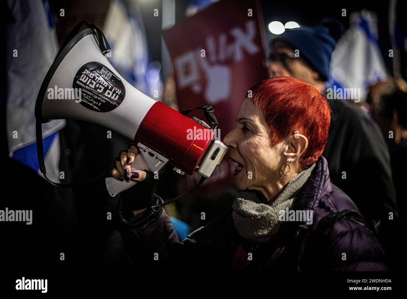 Caesarea, Israele. 20 gennaio 2024. Una donna canta slogan su un megafono durante una protesta fuori dalla casa del primo ministro Benjamin Netanyahu. Gli Stati Uniti, l'Egitto e il Qatar stanno spingendo Israele e Hamas ad accettare un piano globale che ponga fine alla guerra, vedranno il rilascio di ostaggi detenuti a Gaza, e alla fine portano alla piena normalizzazione per Israele con i suoi vicini e a colloqui per la creazione di uno Stato palestinese, il Wall Street Journal ha riferito domenica. (Foto di Eyal Warshavsky/SOPA Images/Sipa USA) credito: SIPA USA/Alamy Live News Foto Stock