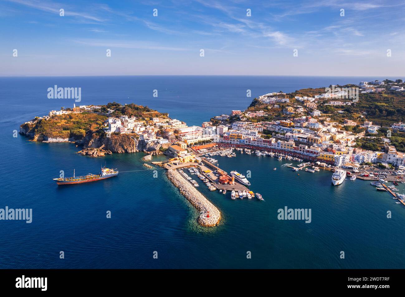Vista aerea delle acque blu intorno al porto dell'isola di Ponza in una giornata di sole, arcipelago pontino, provincia di Latina, mar Tirreno Foto Stock