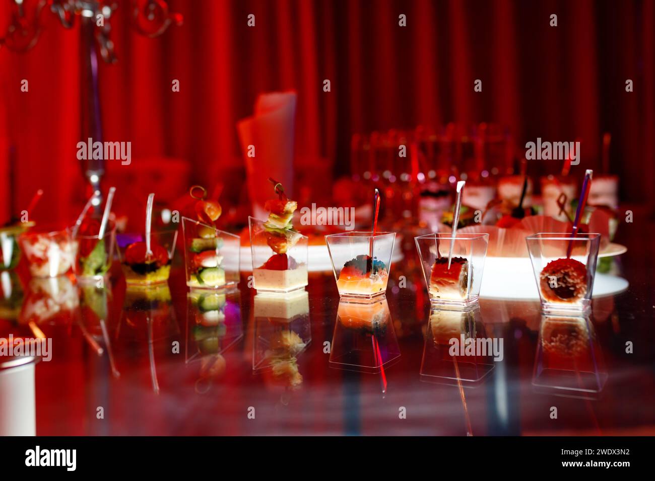 tavolo a buffet con toast, spuntini e dessert in tonalità rosse. Foto di alta qualità Foto Stock