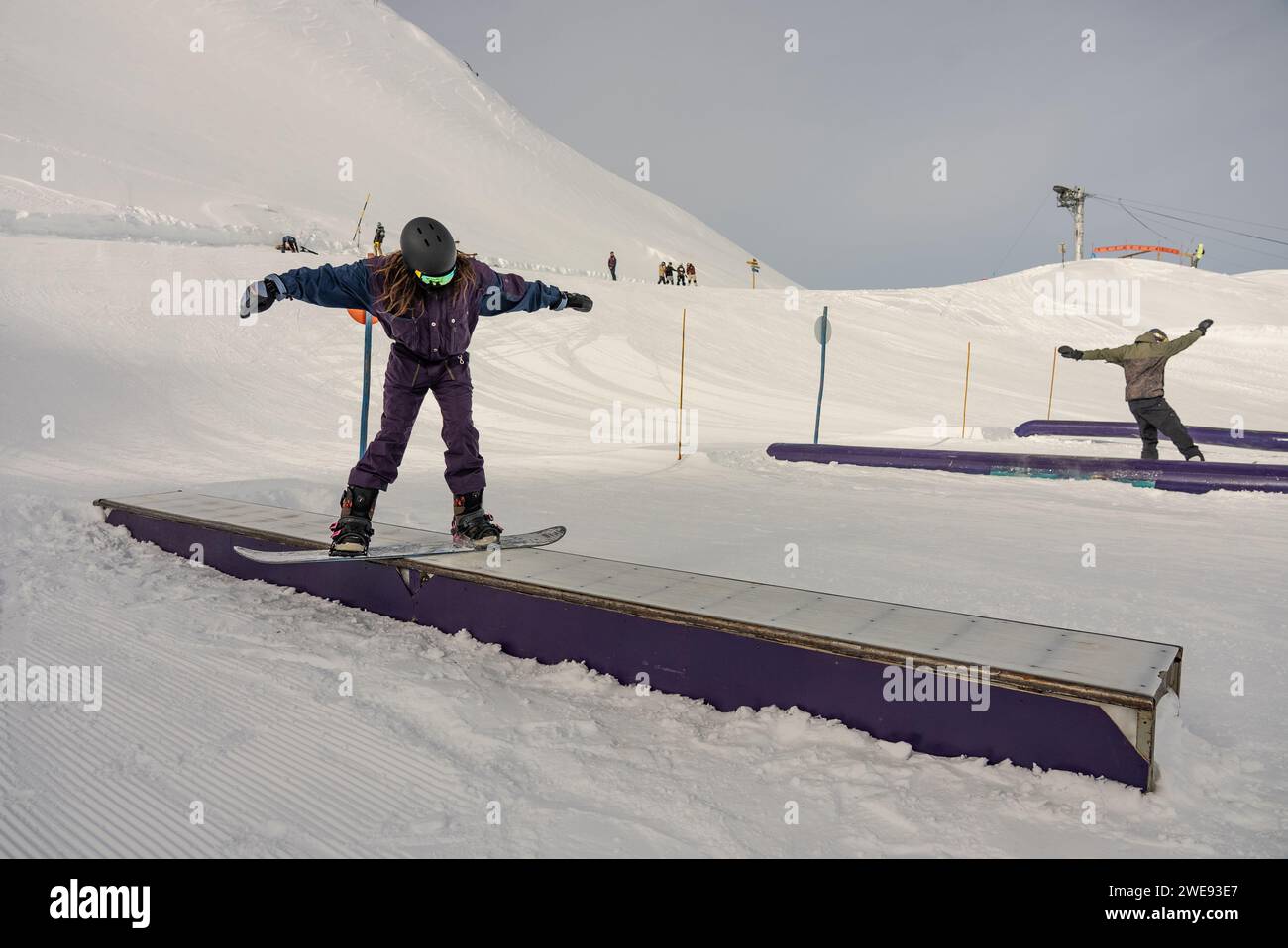 Trucchi per lo Snow Park. Snowboarder nel parco su una scatola. Jibbing invernale nello snwopark in Francia.. Foto Stock