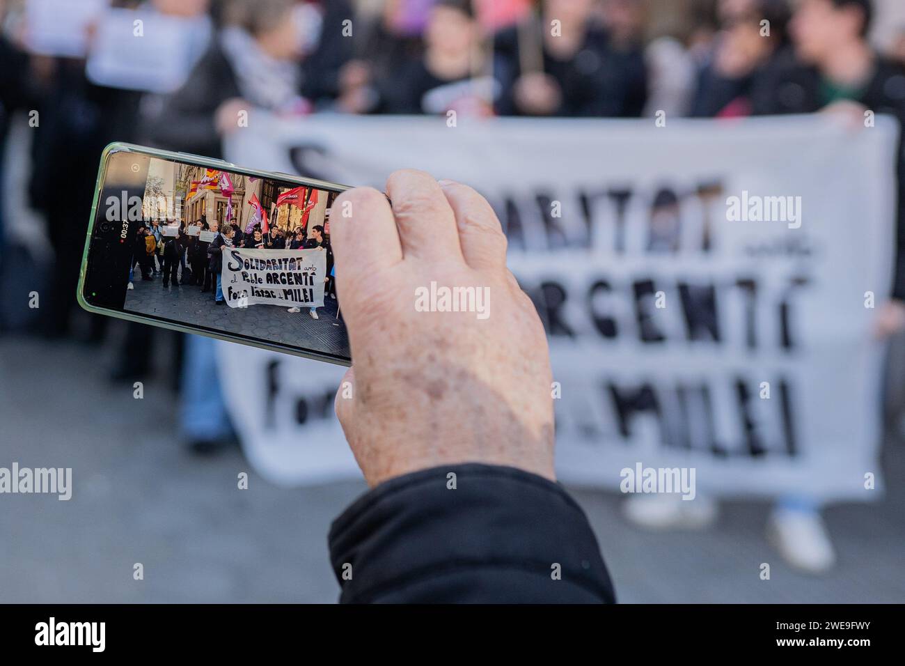 Barcellona, Barcellona, Spagna. 24 gennaio 2024. Decine di persone provenienti dalla comunità argentina di Barcellona e dai sindacati catalani e dalle organizzazioni sociali e politiche di sinistra protestano contro l'ambasciata argentina in coincidenza con lo sciopero nazionale in Argentina. Essi protestano contro il governo di estrema destra di Javier Milei e respingono il cosiddetto Decreto della necessità e dell'urgenza e la legge Omnibus, che rappresentano una storica, antioperaia, pro-datore di lavoro e controriforma asservita agli interessi imperialisti delle multinazionali nordamericane ed europee e del FMI. (Immagine di credito: © ma Foto Stock