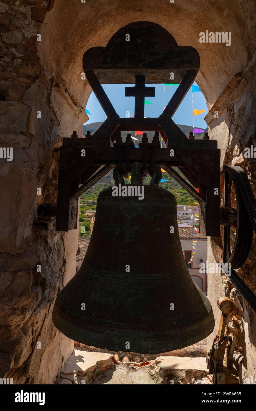 Campana di bronzo su una torre di un'antica chiesa, la chiesa del villaggio di Almudaina, Alicante, Costa Blanca - foto ufficiale Foto Stock