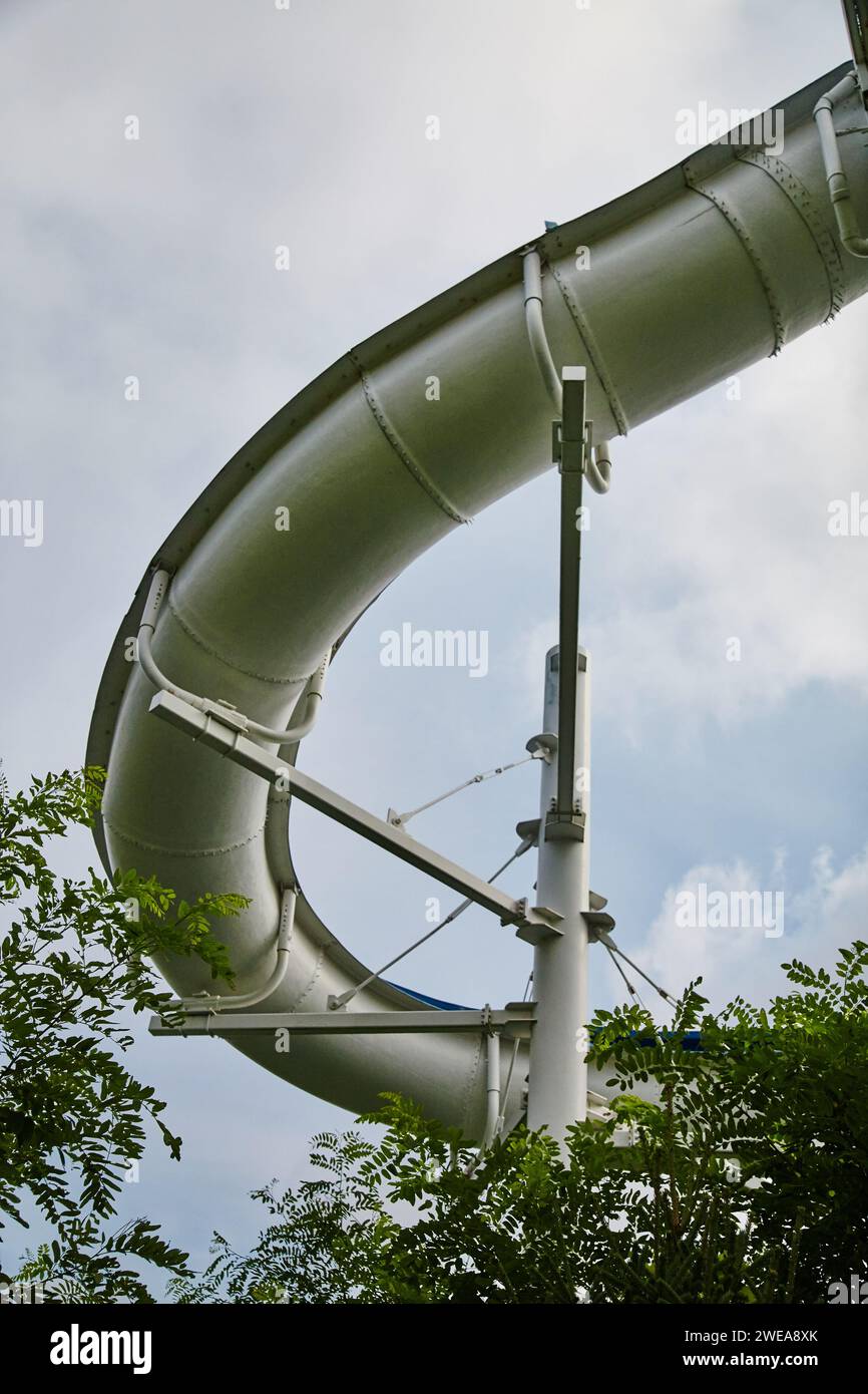 Scivolo acquatico gigante curvo con fogliame verde - Vista da terra Foto Stock