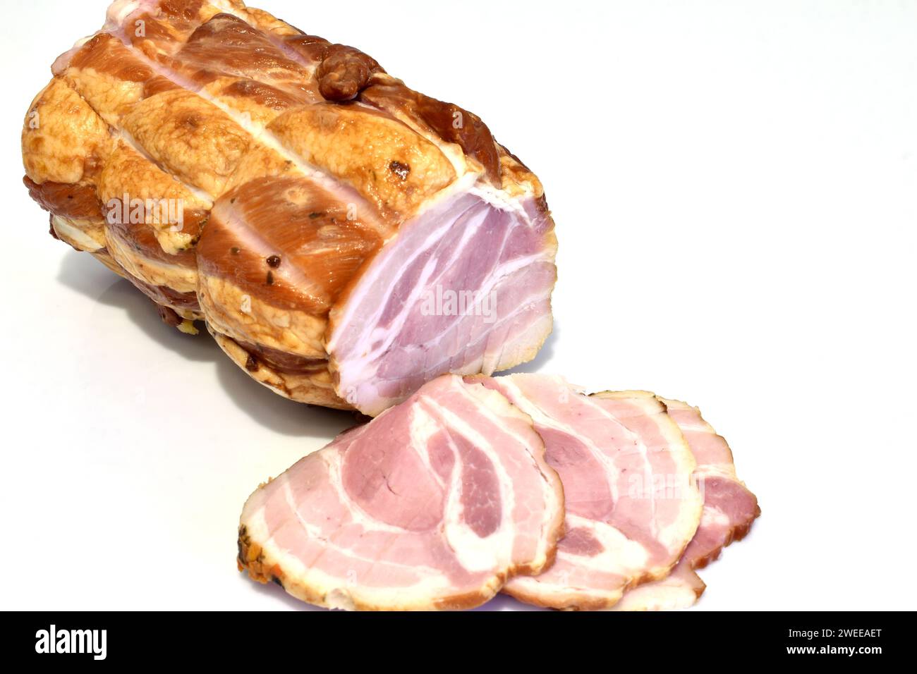 La carne e le fette di coppetta tagliate da essa giacciono su uno sfondo bianco. Foto Stock