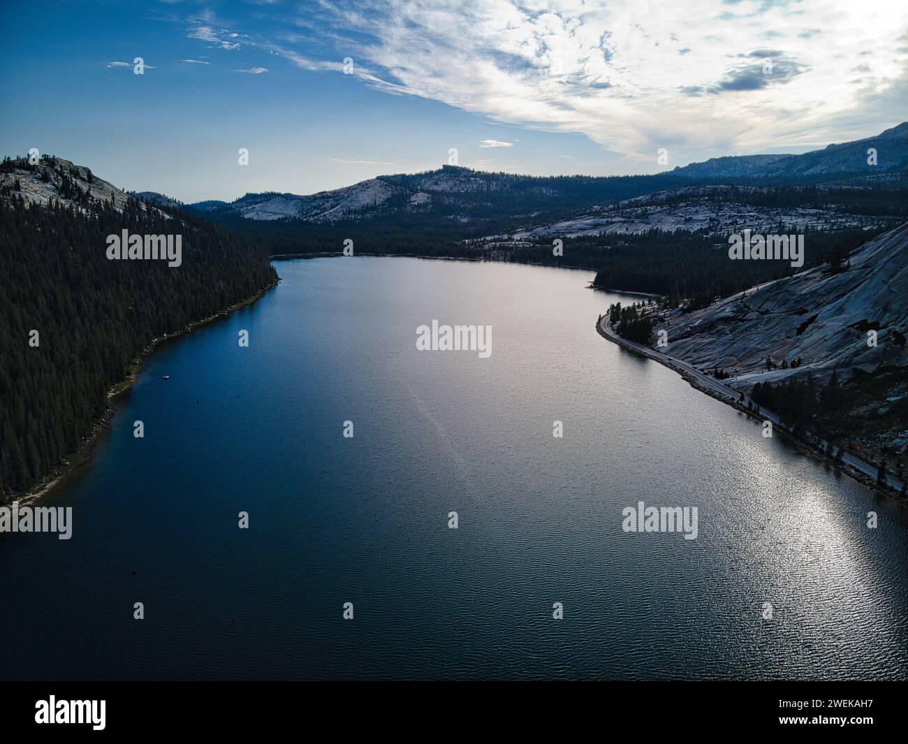 Vista aerea di un tranquillo lago con maestose montagne e alberi lontani Foto Stock