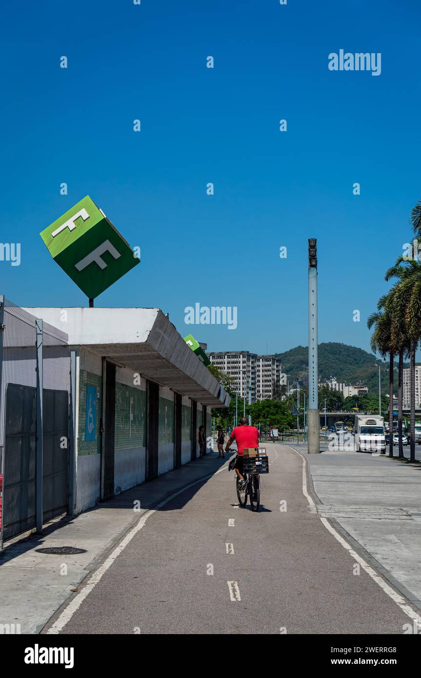 Un ciclista sulla pista ciclabile isolata che corre al settore F dello stadio Maracana, grande marciapiede sul lato nord, vicino a Rei Pele avenue sotto il cielo blu. Foto Stock
