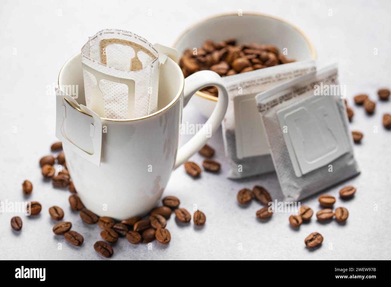 Versare il sacchetto di caffè all'americana con il caffè macinato in tazza. Preparare il caffè appena fatto a casa. Foto Stock