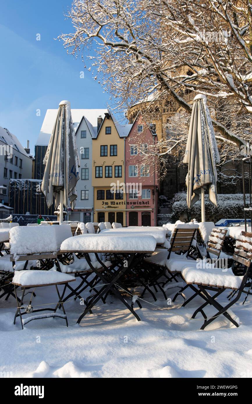 Sedie e tavoli coperti di neve al Fischmarkt nel centro storico, inverno, Colonia, Germania. Schneebedeckte Stuehle und Tische am Fischmarkt in der Alt Foto Stock