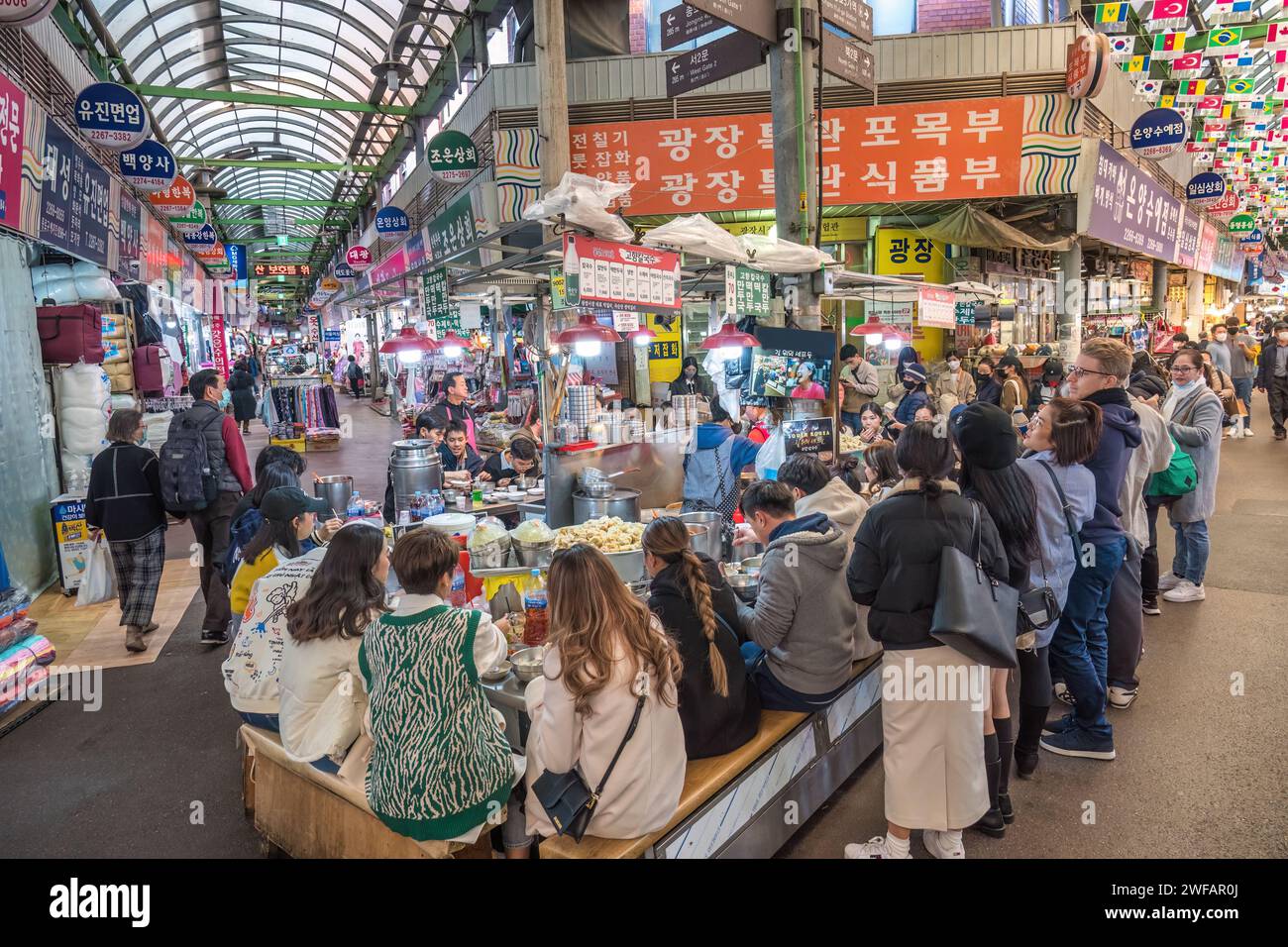 Seoul, Corea del Sud - 11 novembre 2022: Bancarelle di negozi e Street food con molti turisti al mercato di Gwangjang Foto Stock