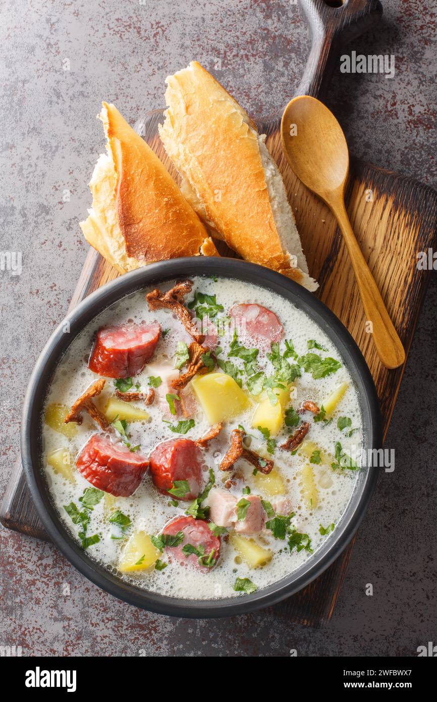 La zalewajka è una zuppa tradizionale polacca a base di zuppa di grano intero, salsiccia affumicata, pancetta aromatica affumicata e verdure da radice da vicino sul PL Foto Stock