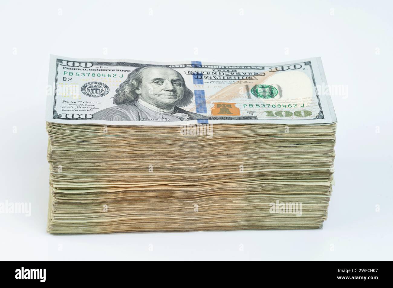 Una grande pila di dollari americani in contanti di 100 isolati su sfondo bianco Foto Stock