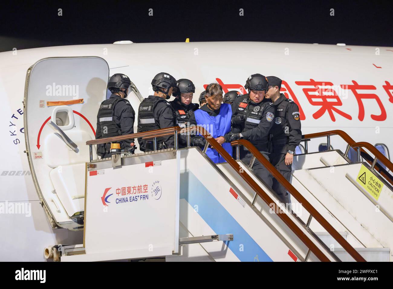 (240131) -- KUNMING, 31 gennaio 2024 (Xinhua) -- sospetto criminale Bai sul Cheng è scortato da agenti di polizia cinesi presso l'aeroporto internazionale Kunming Changshui di Kunming, provincia dello Yunnan, nella Cina sud-occidentale, 30 gennaio 2024. Martedì la polizia del Myanmar ha consegnato sei leader chiave delle bande di frode delle telecomunicazioni Kokang e altri quattro principali sospettati criminali in Cina, secondo il Ministero della pubblica sicurezza cinese. I dieci sospettati sono stati scortati da agenti di polizia cinesi di nuovo in Cina tramite un volo charter atterrato a Kunming martedì sera, ha detto il ministero, aggiungendo che si tratta di un altro landma Foto Stock