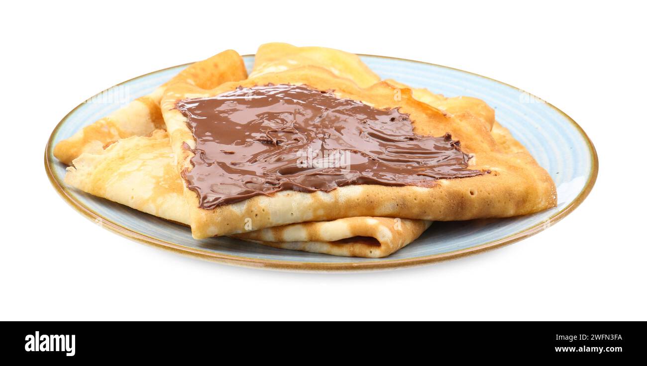 Crepes gustose con pasta di cioccolato isolata su bianco Foto Stock