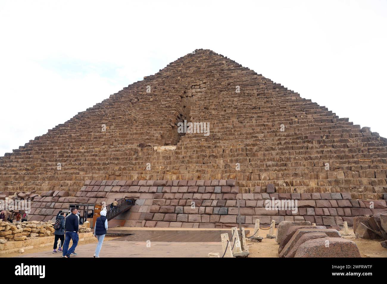 Giza, Egitto. 31 gennaio 2024. I turisti visitano la Piramide di Menkaure a Giza, Egitto, 31 gennaio 2024. Il piano del Consiglio Supremo delle Antichità dell'Egitto (SCA) per rivestire la Piramide di Menkaure, una delle famose tre piramidi di Giza, con blocchi di granito sollevò il dibattito nel paese poiché alcuni archeologi temono che rovinerebbe l'originalità del monumento di 4.500 anni fa. Credito: Ahmed Gomaa/Xinhua/Alamy Live News Foto Stock