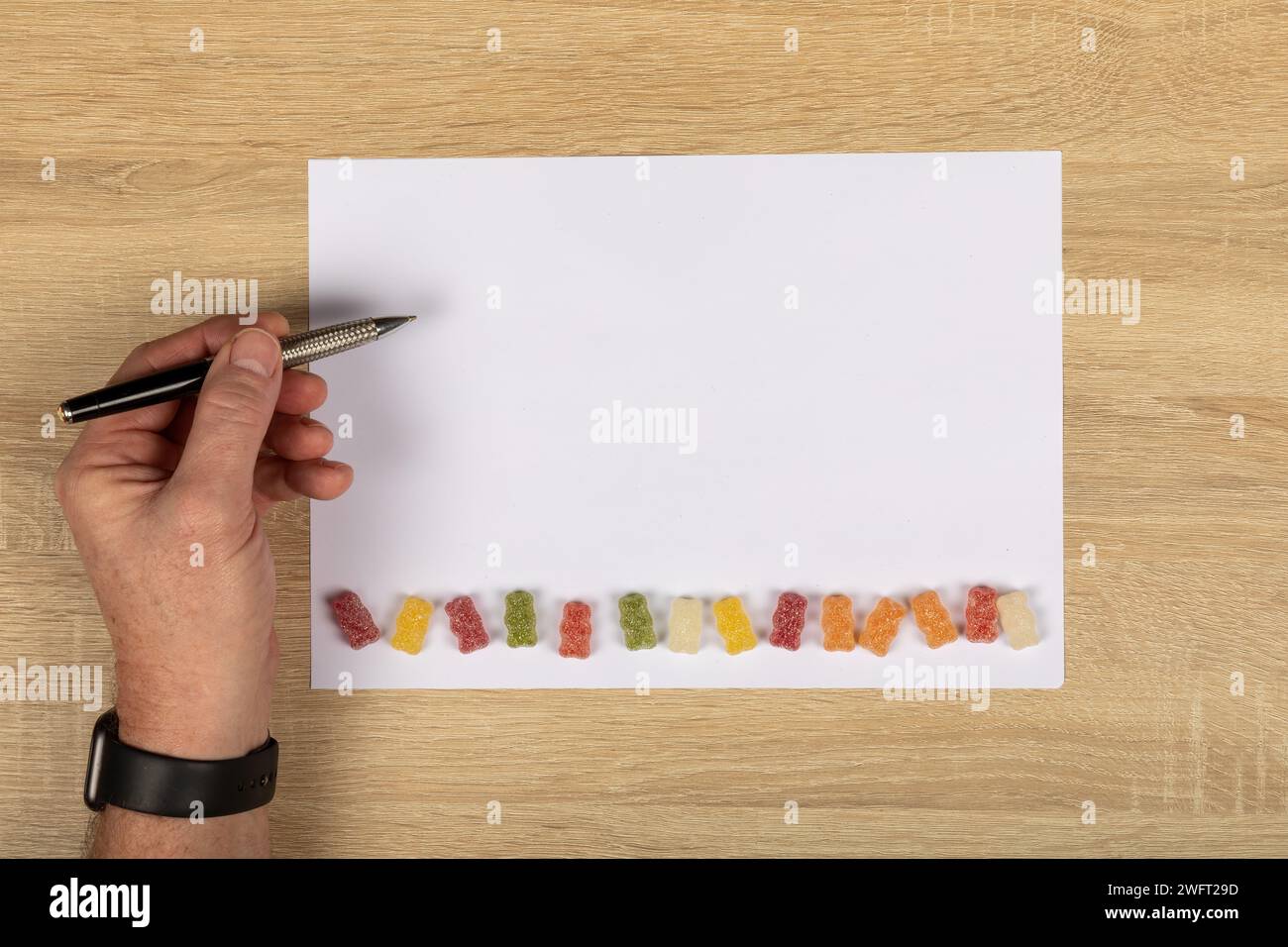 Insegnamento mancino: Scrittura creativa con dolci dolcetti per bambini su White paper con spazio copia. Foto Stock