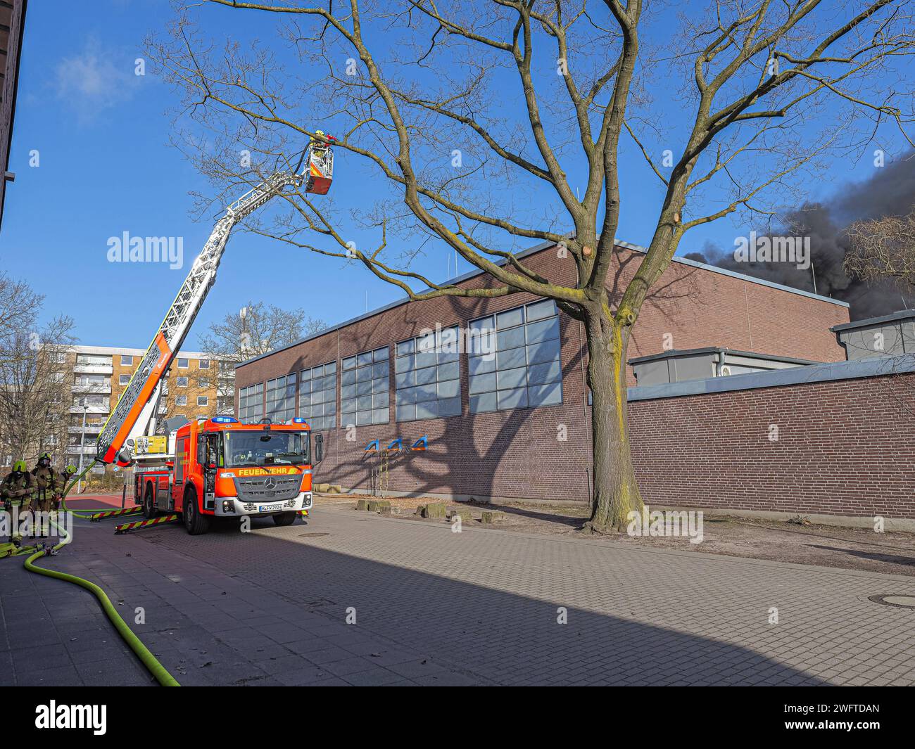 Gleich mit mehreren Drehleitern konnte die Feuerwehr heute Mittag den Brand einer Voltaikanlage auf der Turnhalle der Herschelschule bekämpfen. *** Il dipartimento dei vigili del fuoco ha usato diverse scale giradischi per combattere l'incendio in un impianto voltaico sulla palestra della scuola Herschel questo pomeriggio Foto Stock