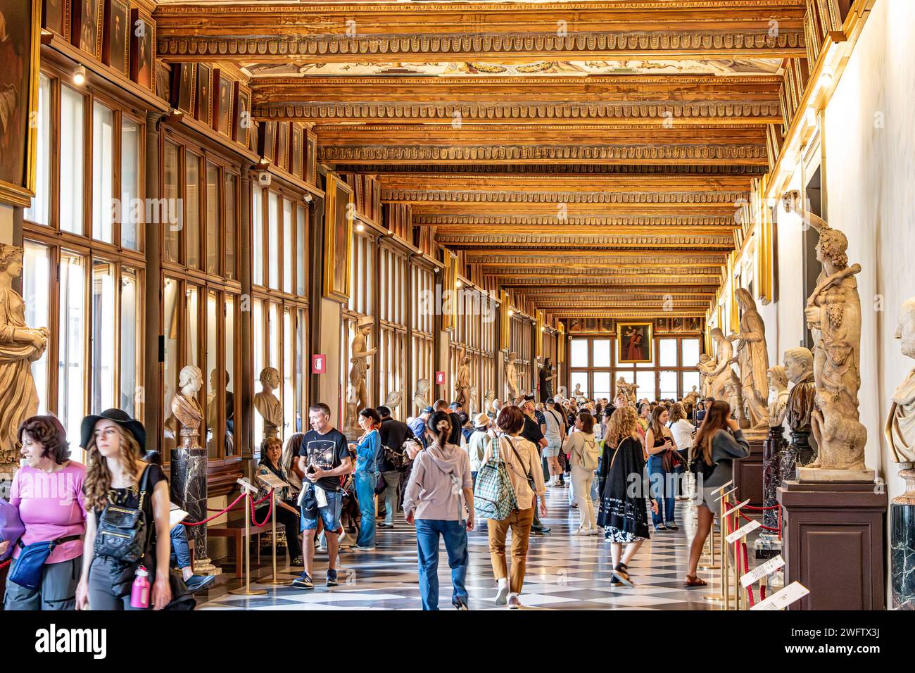 Persone che ammirano le opere d'arte all'interno della Galleria degli Uffizi, uno dei migliori musei d'arte al mondo a Firenze Foto Stock