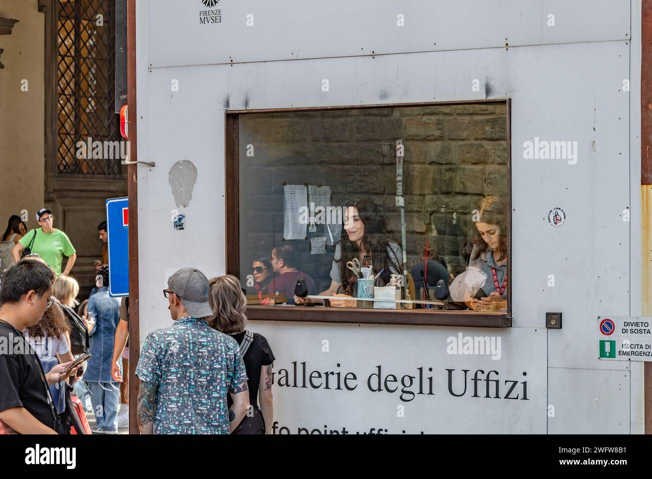 Le persone che si trovano vicino a un chiosco di aiuto per i visitatori presso la Galleria degli Uffizi a Firenze, Italia Foto Stock
