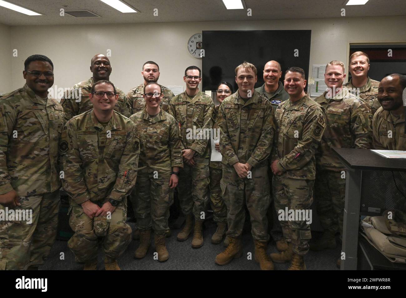 I membri dell'aeronautica militare degli Stati Uniti del 36th Airlfit Squadron posano per una foto di gruppo con l'Airlifter of the Week, Senior Airman Dorian Ortega (al centro) presso la base aerea di Yokota, Giappone, 12 gennaio 2024. SRA Ortega è un C130J debrief Journeyman per il 36th Airlift Squadron. Esegue procedure di debrief degli aeromobili responsabili dell'immissione dei dati di missione, del tracciamento storico dei dati e della segnalazione. Foto Stock