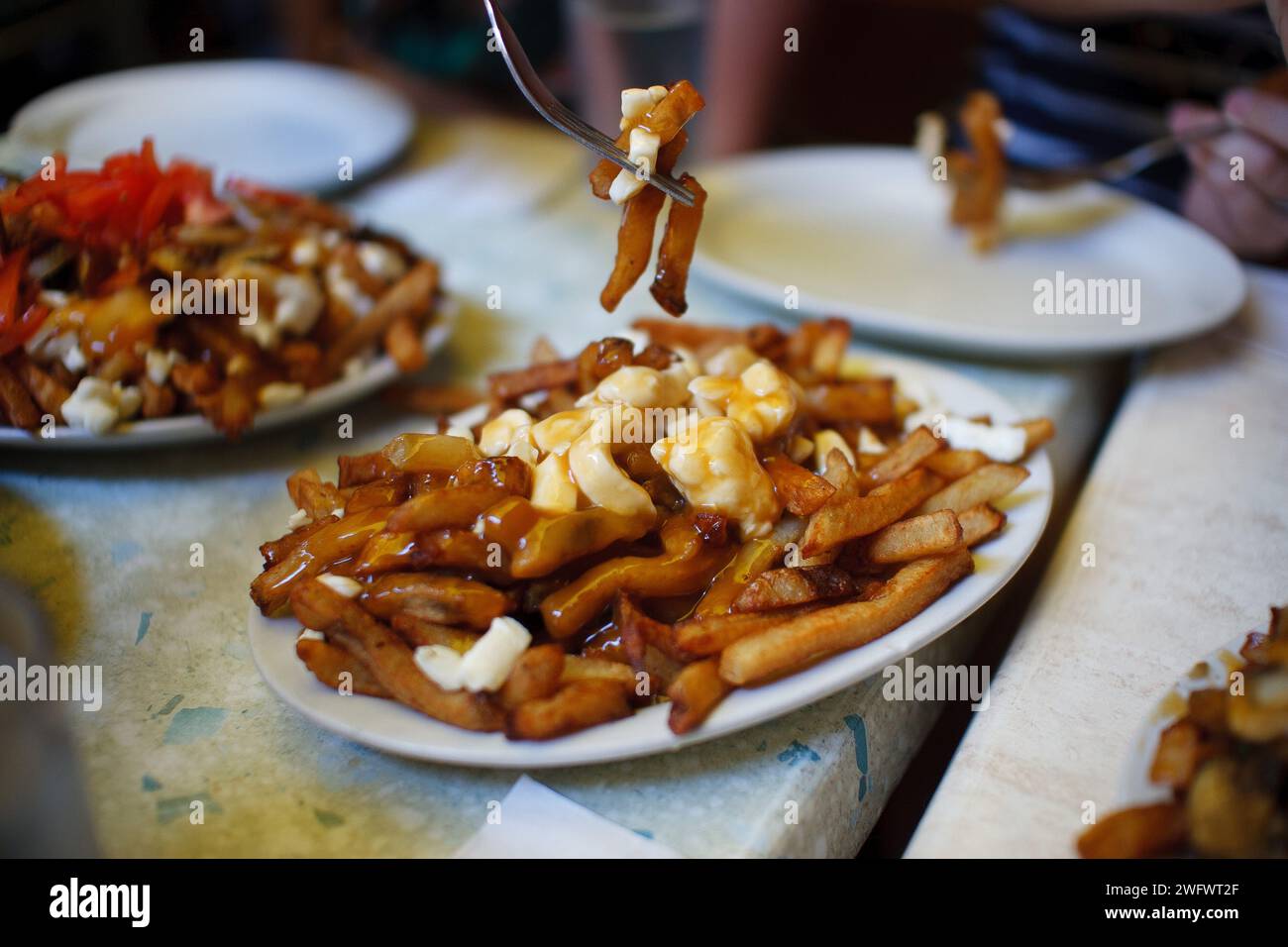 Poutine per famiglie in un ristorante a Montreal, Quebec, Canada Foto Stock