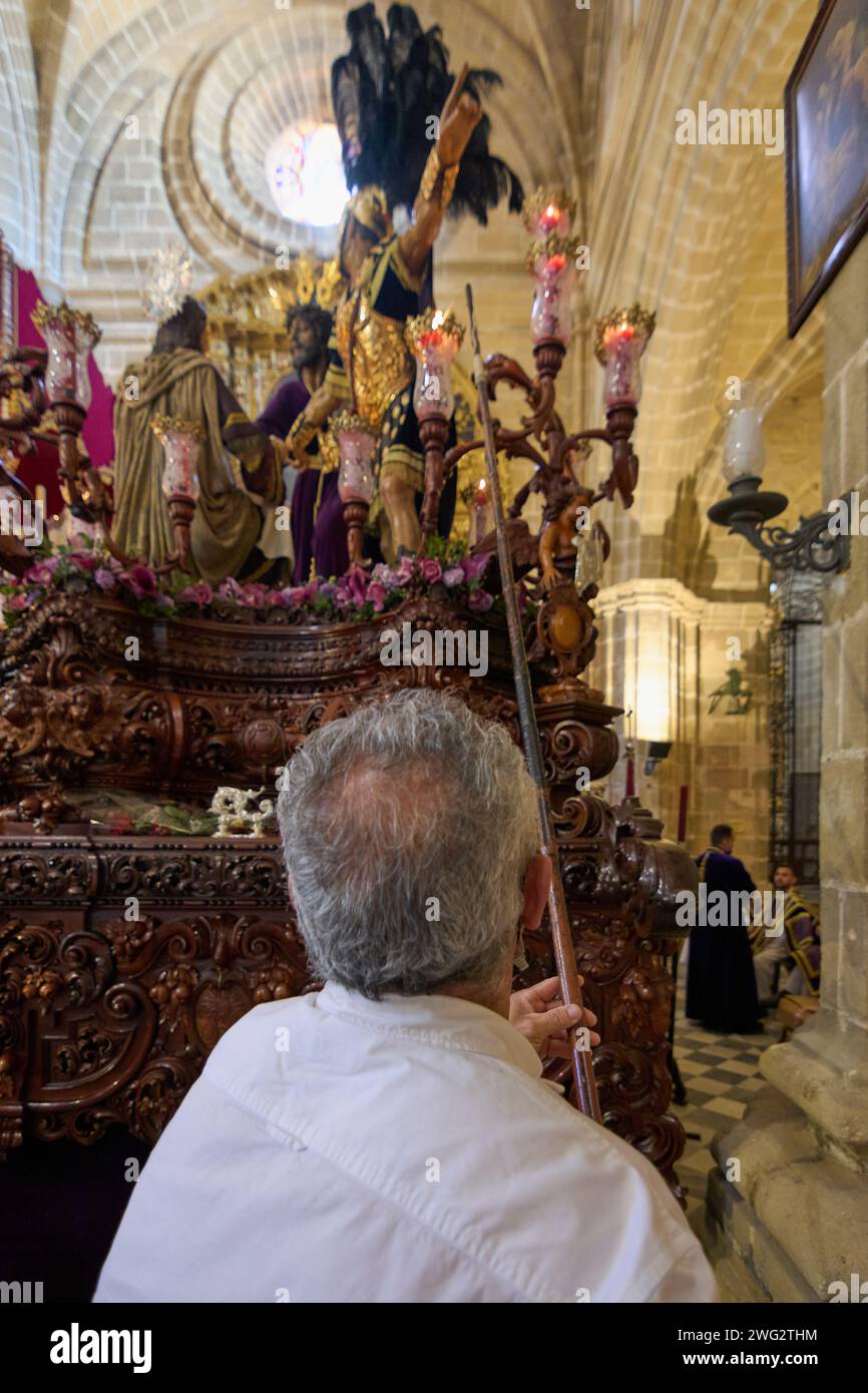 Jerez de la Frontera, Spagna - 2 febbraio 2024: Jerez de la Frontera, Spagna - 2 febbraio 2024: Uomo irriconoscibile che accende le candele di una settimana Santa Foto Stock