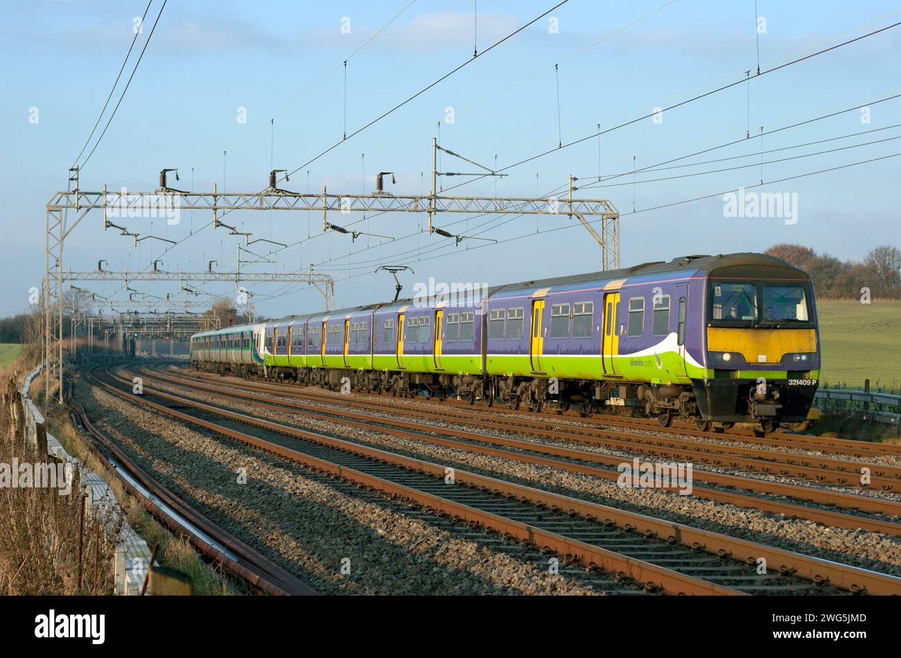 Un paio di unità multiple elettriche di classe 321 guidate da 321409 che lavorano in un servizio Silverlink presso Dudswell. Foto Stock