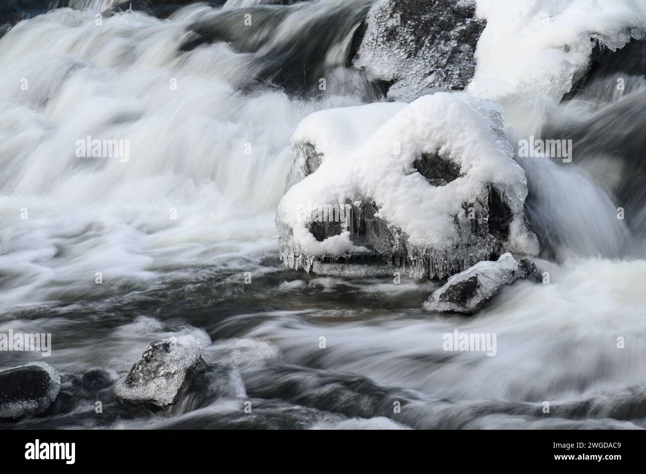Una faccia ghiacciata in un fiume che infuria Foto Stock