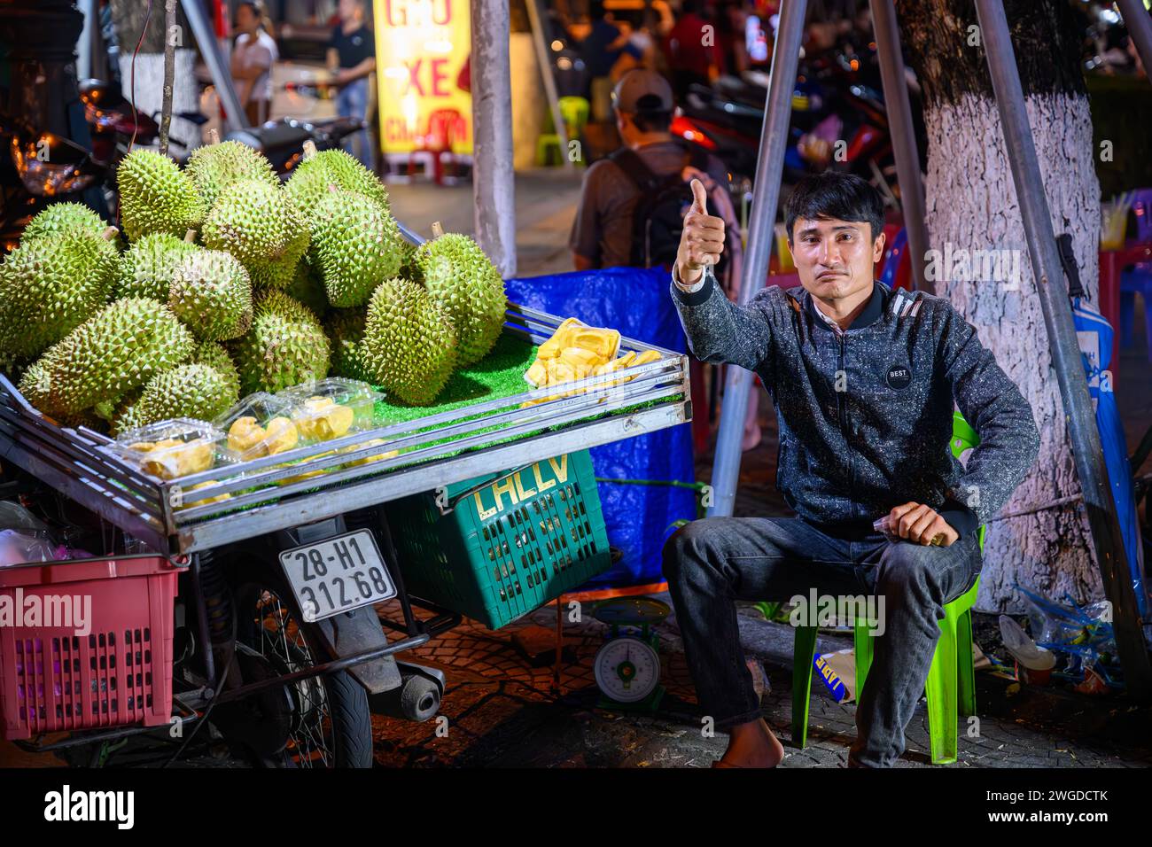 Un entusiasta venditore di frutta Durian al mercato notturno Son tra, da Nang, Vietnam Foto Stock