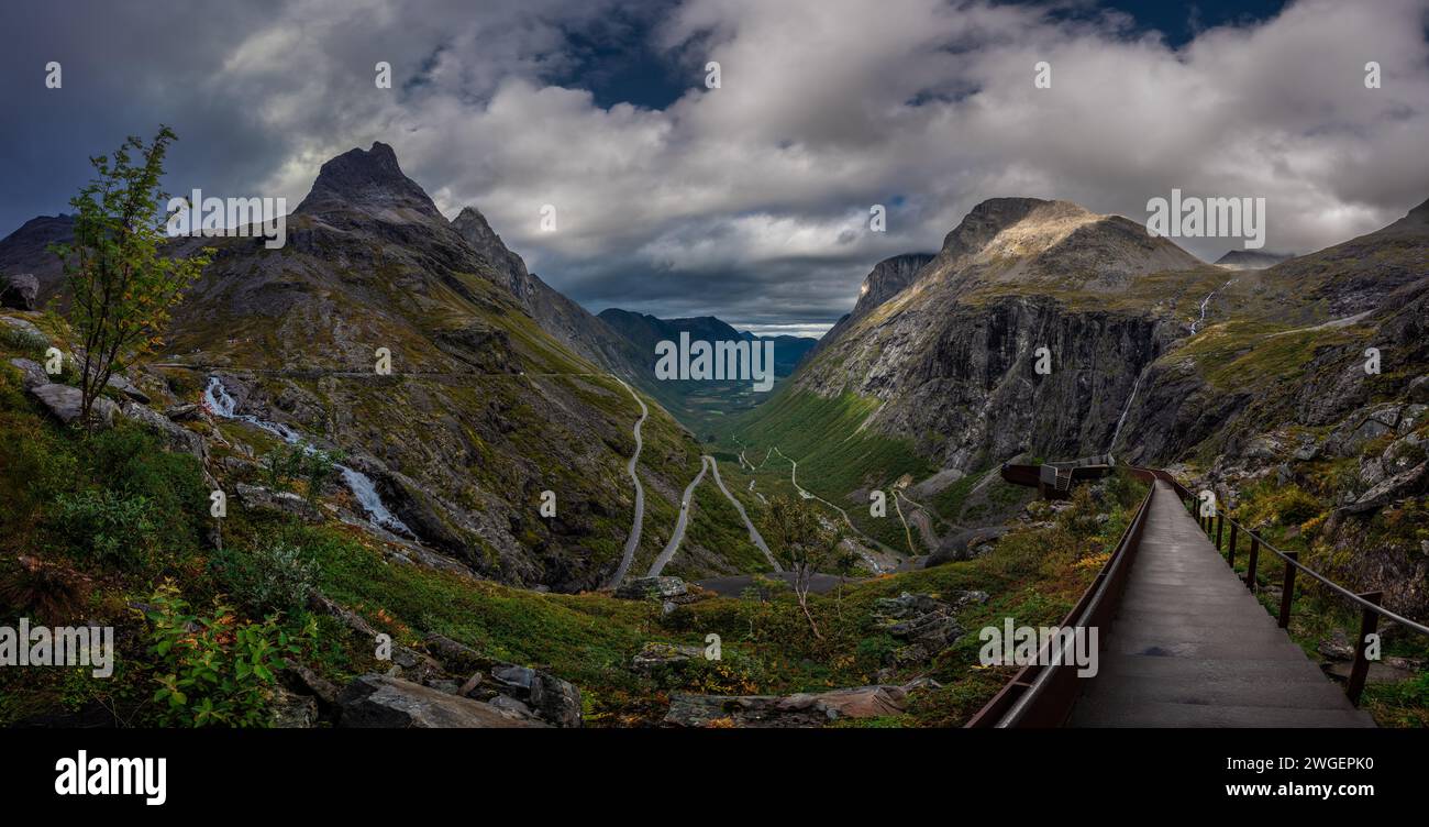 Scale che conducono alla piattaforma panoramica di Trollstigen con cascata e strada tortuosa sottostante Foto Stock