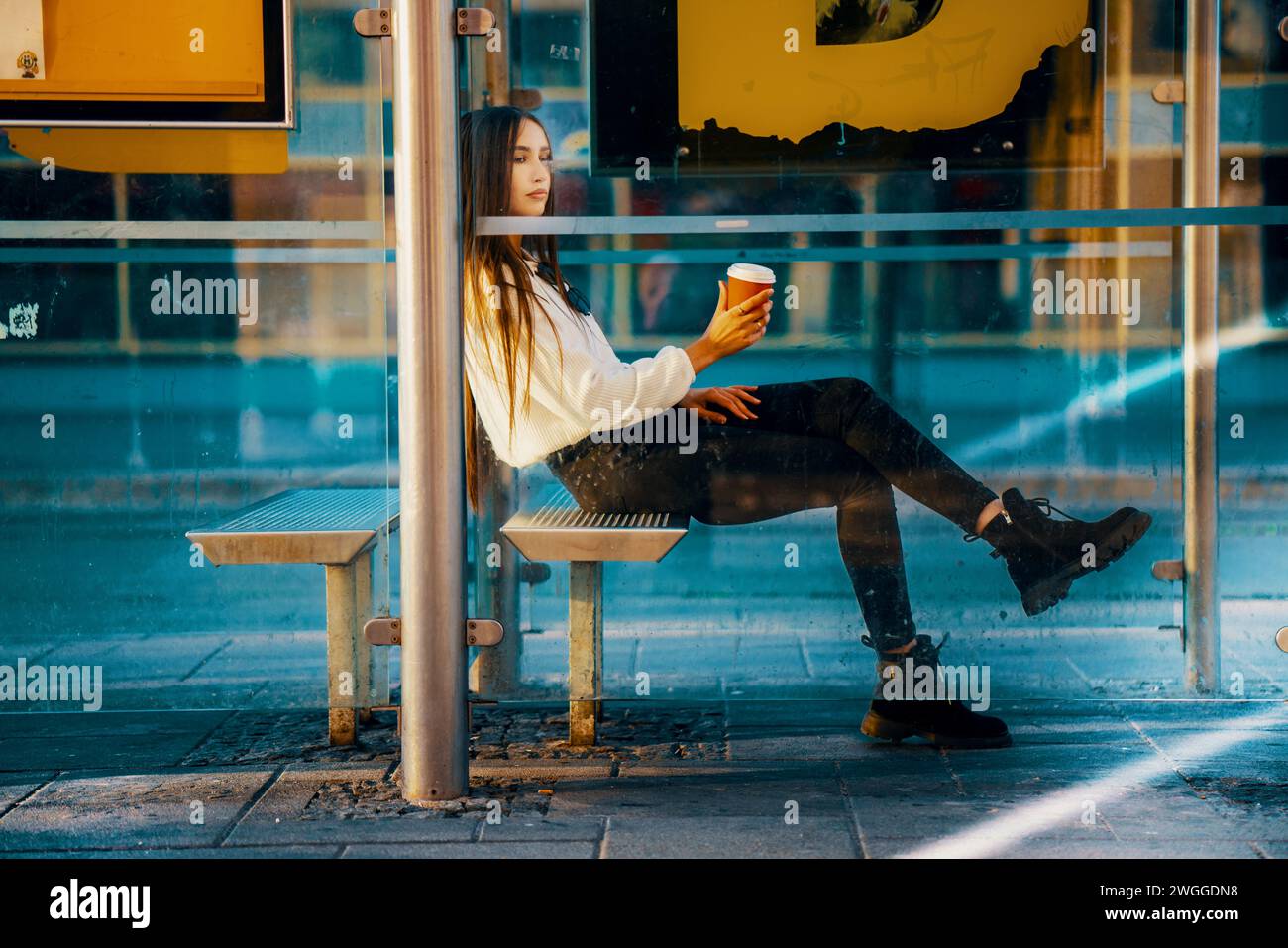 Giovane adulto che si rilassa all'aperto nello skyline contemporaneo di Metropolis. Foto Stock