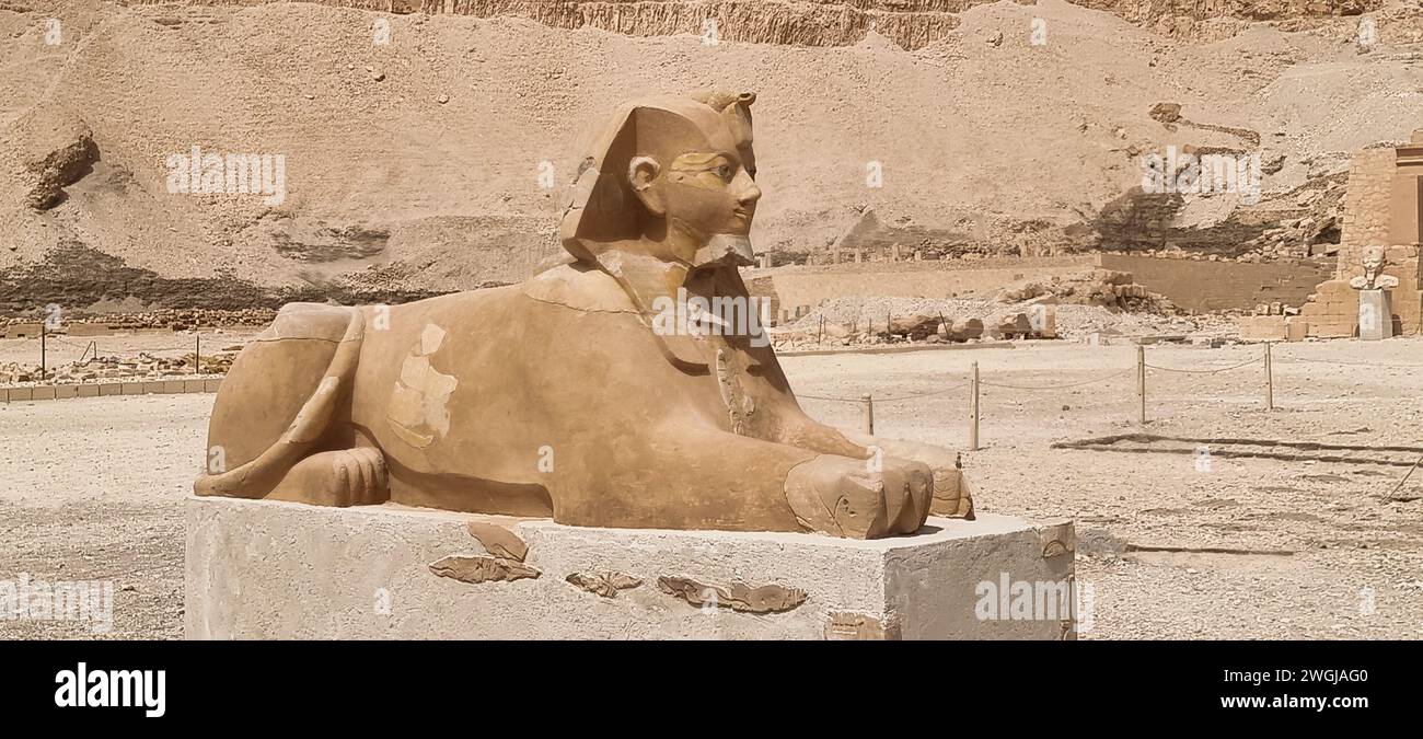 Un'antica statua in pietra egiziana con maestoso sfondo di montagna Foto Stock