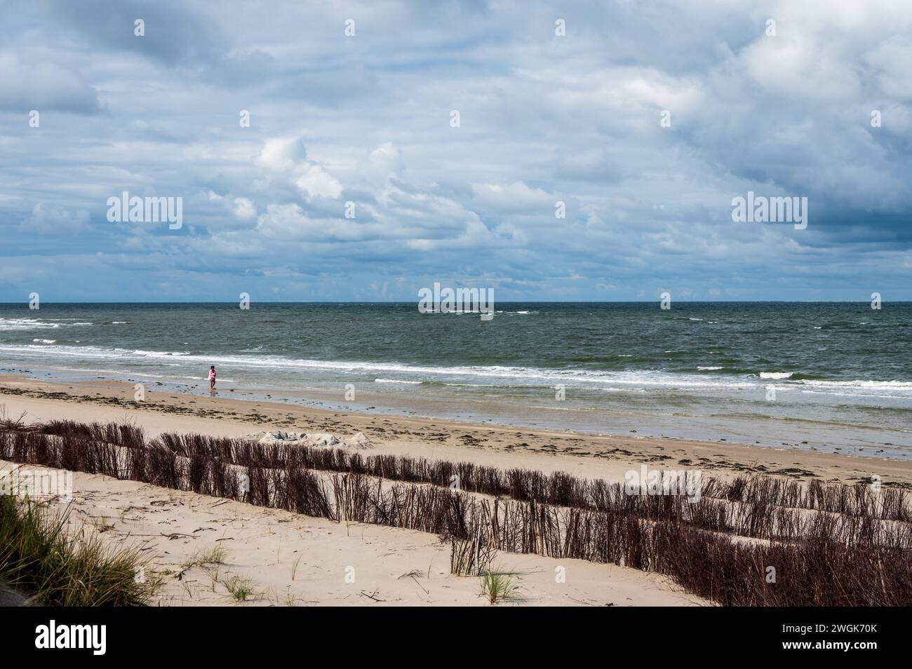 Spaziergänger am feinen Sandstrand von Amrum bei Norddorf, im Vordergrund Maßnahmen für den Küstenschutz *** escursionisti sulla spiaggia di sabbia fine di Amrum vicino a Norddorf, con misure di protezione costiera in primo piano Foto Stock