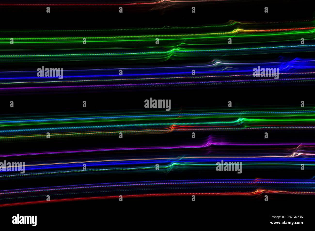 Linee d'onda colorate astratte su sfondo nero. Fotografia a lunga esposizione Foto Stock