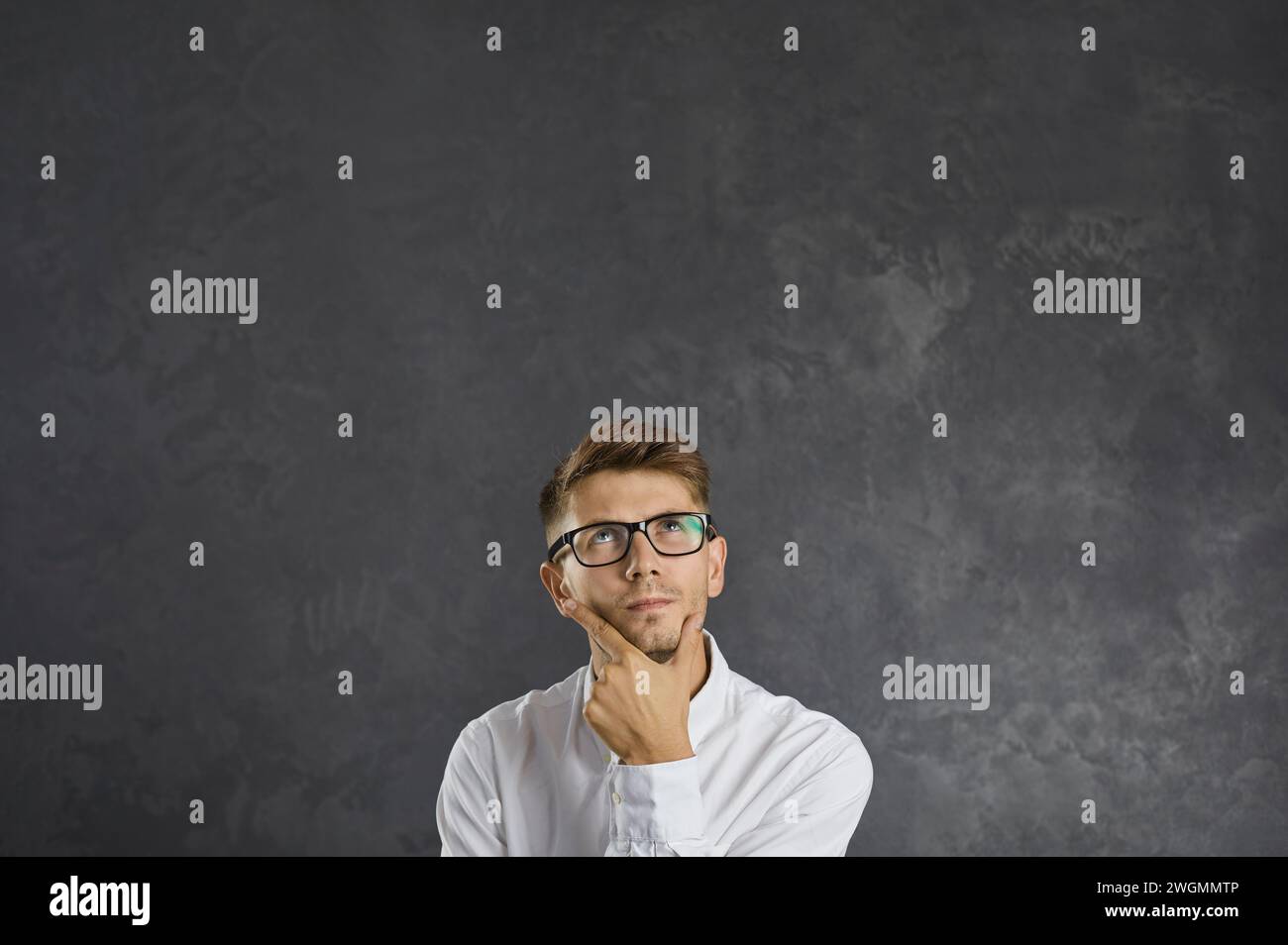 Ritratto di un giovane confuso e perplesso che sta pensando attentamente a qualcosa. Foto Stock