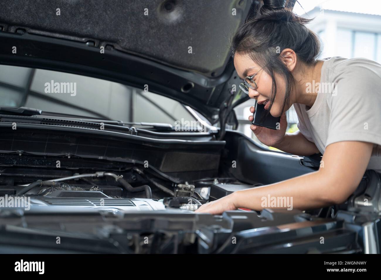 Hai bisogno di aiuto con il guasto dell'auto donna seria ascolta i consigli e la spiegazione del servizio di riparazione auto di emergenza al telefono. Foto Stock