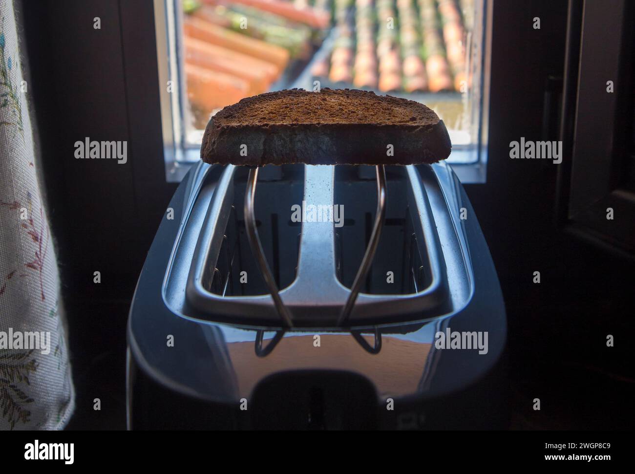 Tostapane posto sul davanzale di una casa rurale. Fetta fresca su rack Foto Stock