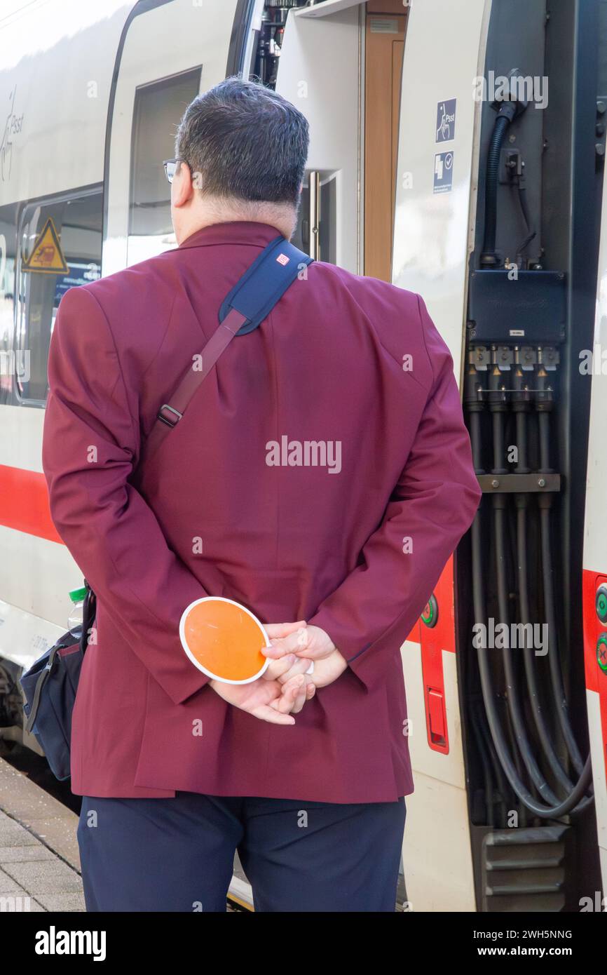 Addetto alla stazione centrale di Mannheim (Germania) di fronte a un treno ICE in partenza Foto Stock