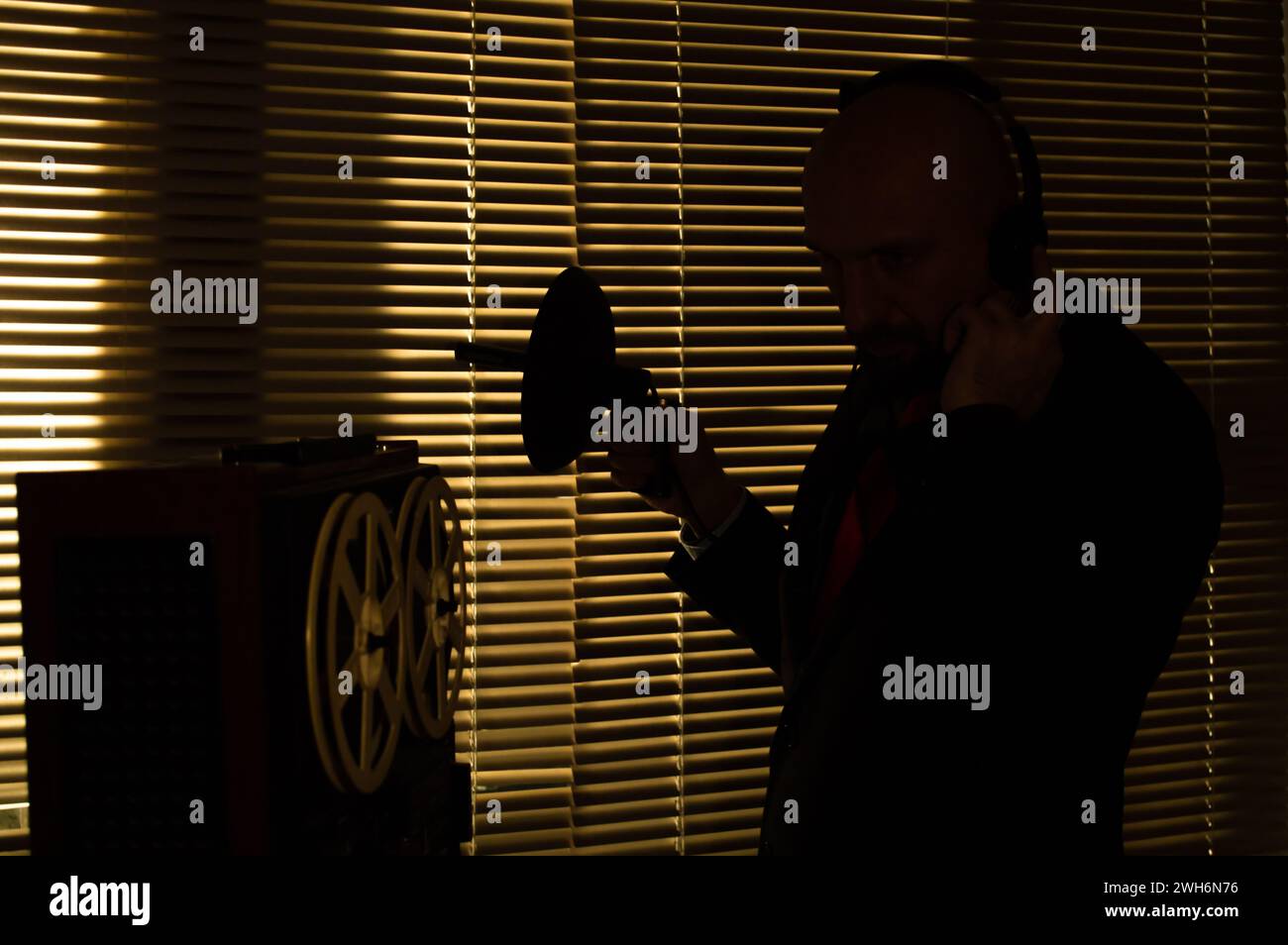 Un agente del KGB ascolta una conversazione importante, registra il suono su un registratore a bobina. Foto Stock
