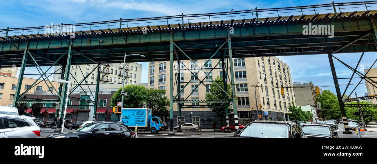 New York, USA; 3 giugno 2023: I tipici binari del treno aereo e del tram del Bronx, che è un quartiere della grande Mela, sotto un cielo azzurro Foto Stock