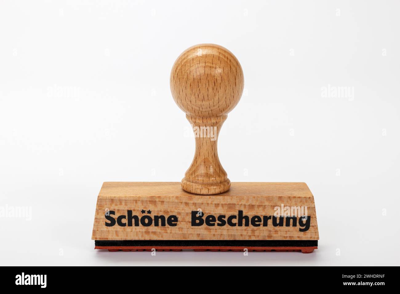 Timbro in legno con iscrizione "Schöne Bescherung", fondo bianco, Foto Stock