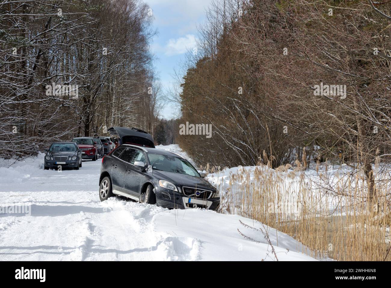Un incidente di un'auto nera in inverno, che scivolò fuori strada Foto Stock