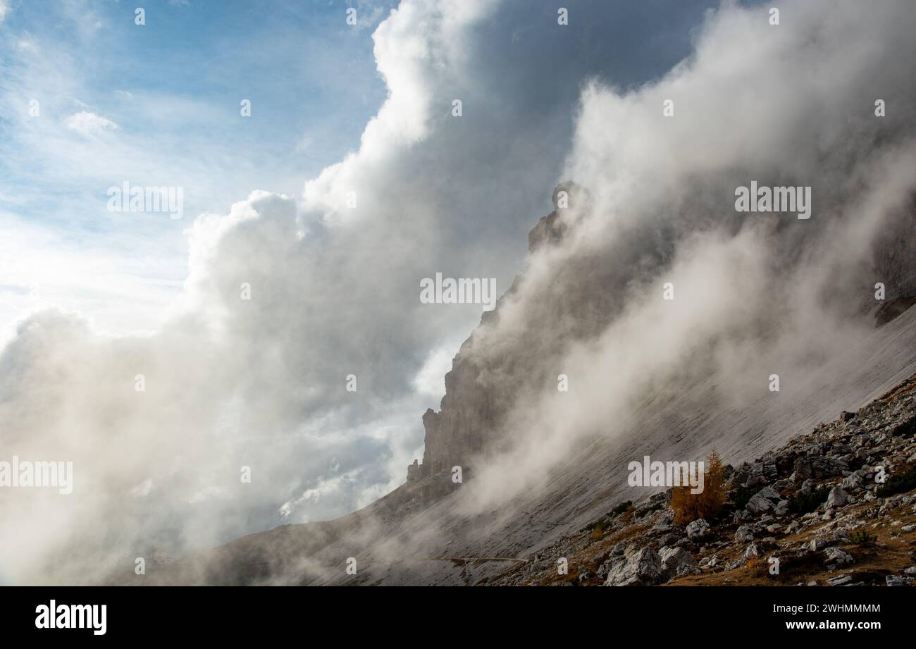 Cime nuvolose e nebulose coperte di nebbia al mattino. Montagne rocciose dolomitiche Italia Foto Stock