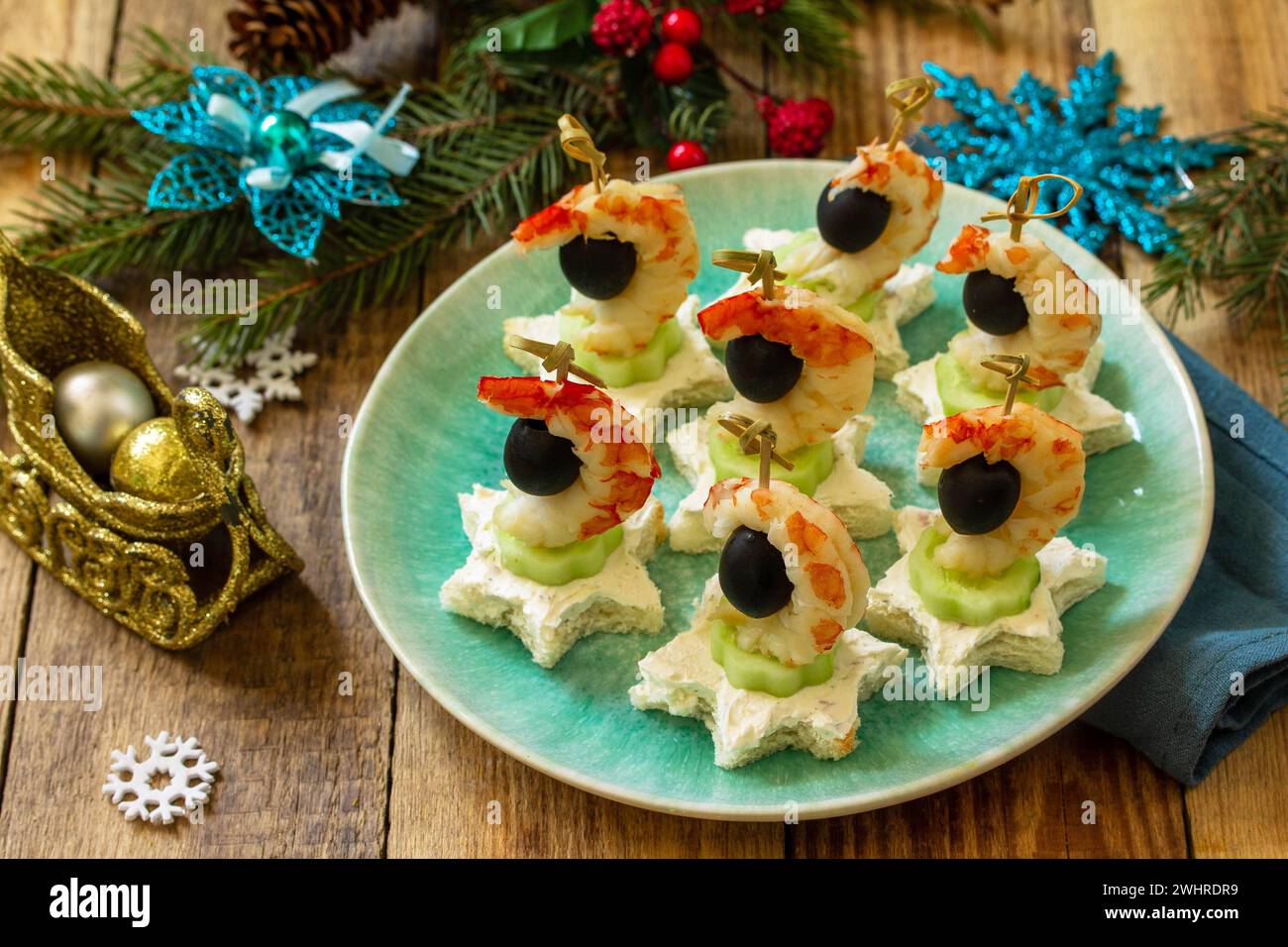 Spuntino festivo di tartine sul tavolo di Natale. Tartine con formaggio, cetrioli e gamberetti. Foto Stock