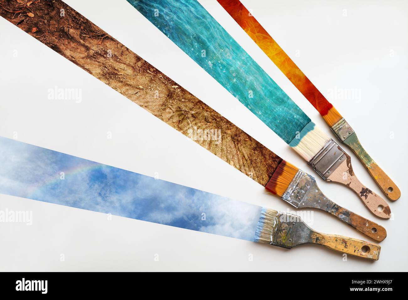 Pennello dipingendo i quattro elementi della natura, fuoco, acqua, terra e aria su sfondo bianco, concetto di ecologia per en Foto Stock