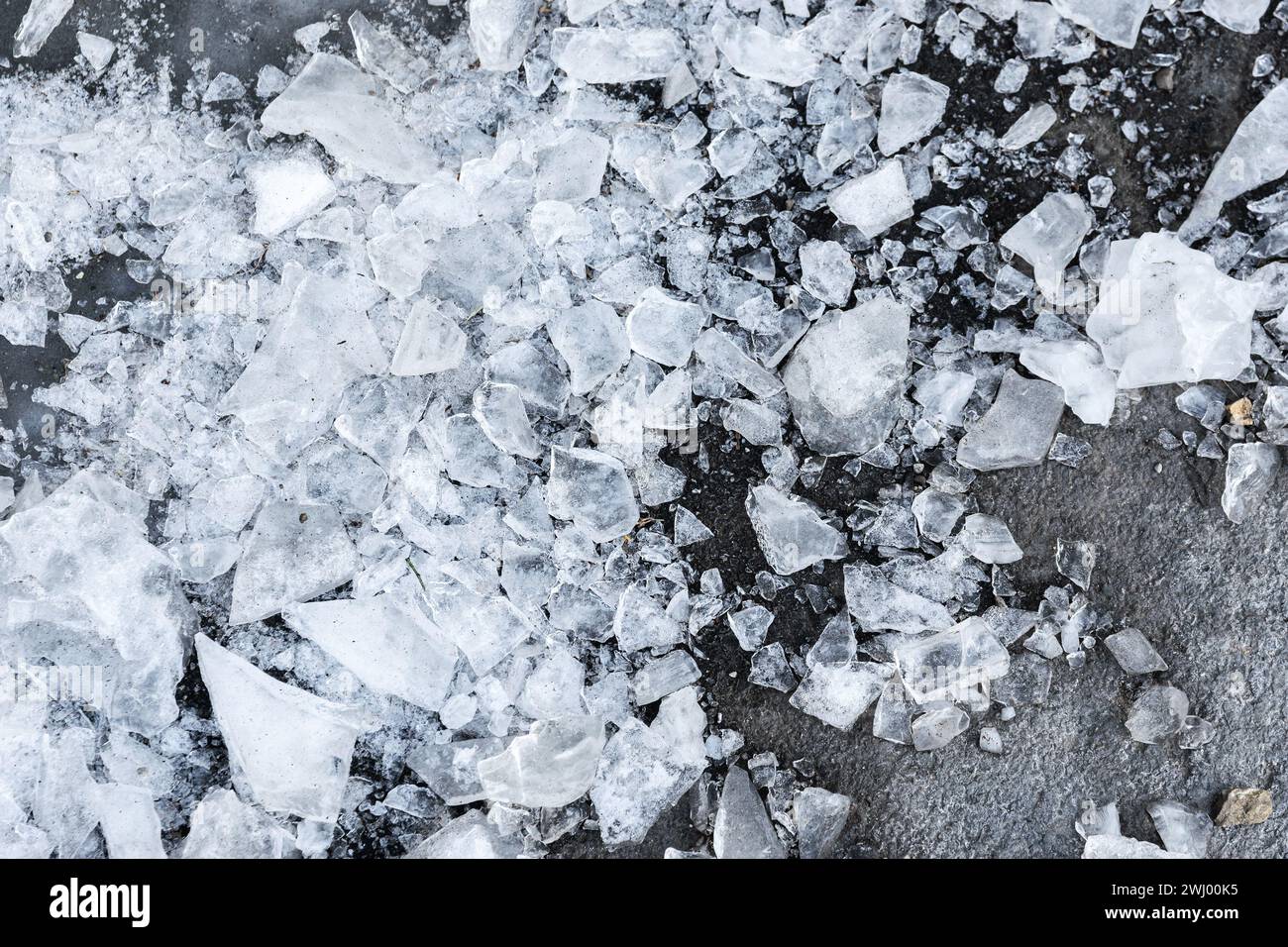 Frammenti di ghiaccio sull'asfalto. Foto Stock