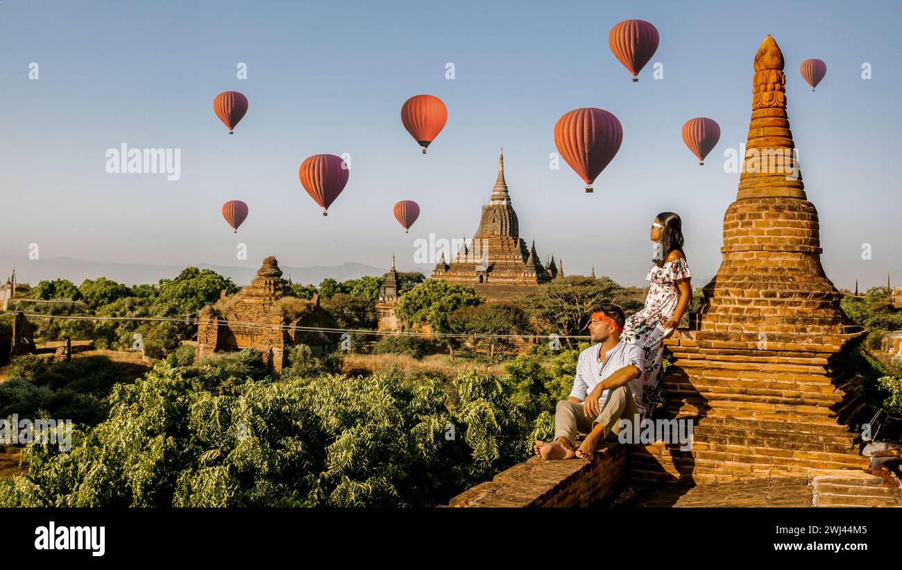 Bagan Myanmar, due uomini e donne che guardano l'alba in cima ad un vecchio tempio pagoda Foto Stock